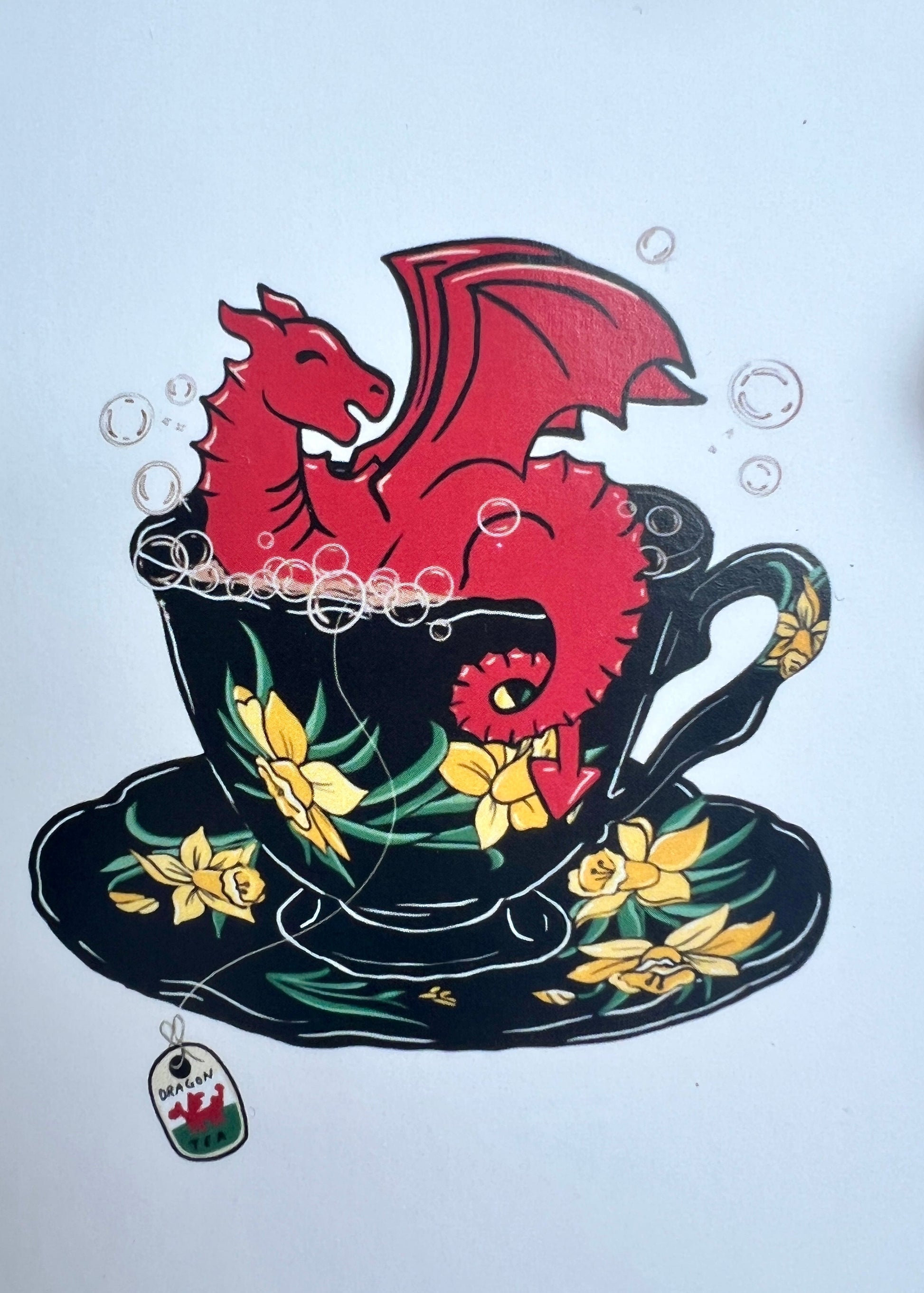 Teacup with red dragon design on a white background